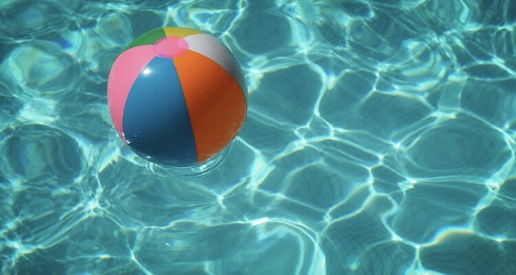 Colorful beach ball in a summer pool — summer mental training for athletes
