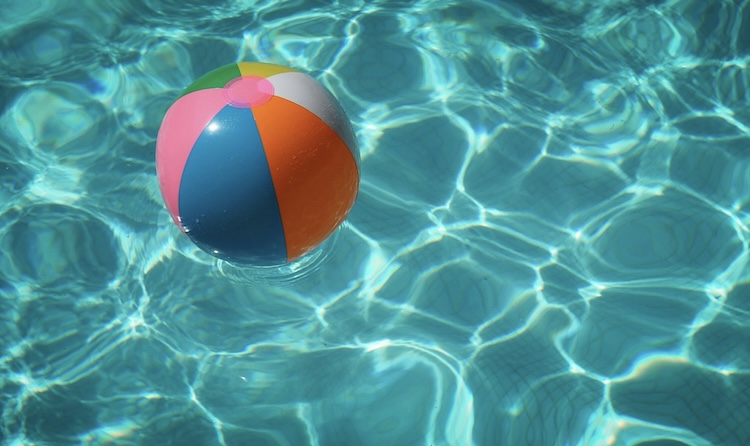 Colorful beach ball in a summer pool — summer mental training for athletes
