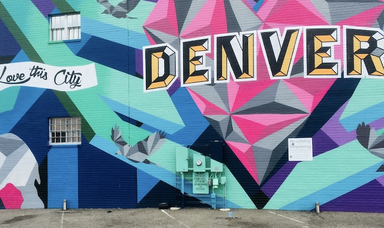 Colorful “Love This City” Denver mural with geometric shapes in pink, blue, and teal, a favorite stop among fall activities in Denver